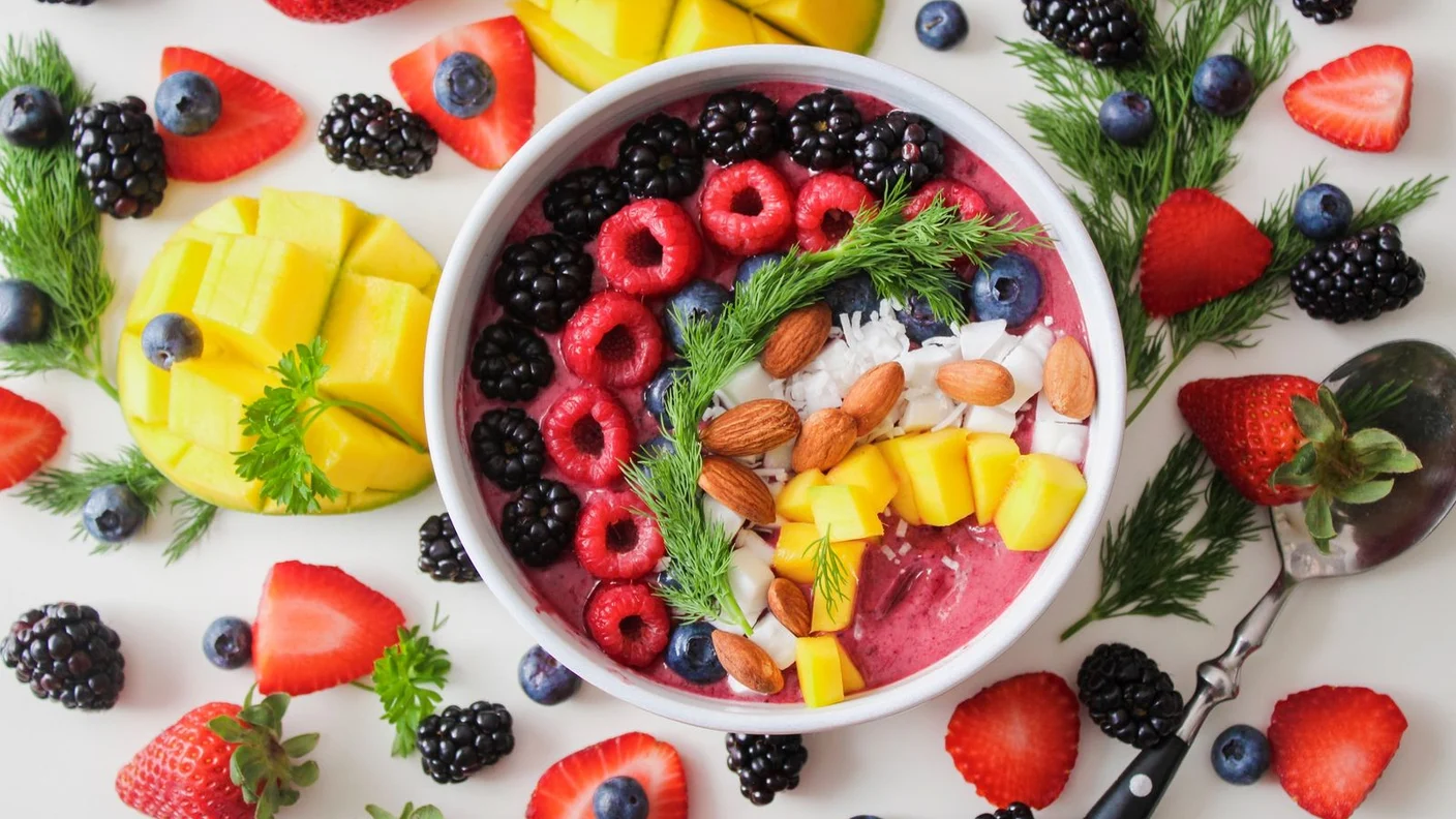A berry and yogurt bowl with nuts and seeds, fibre and fermented foods that nourish the gut microbiome and the gut-brain axis.